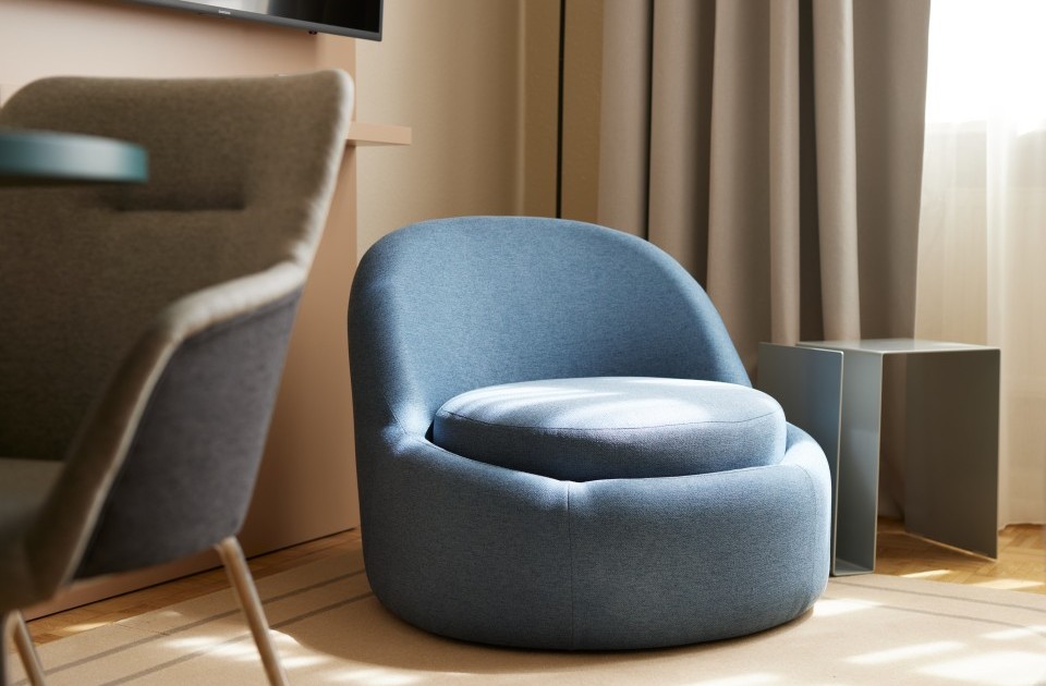 Moderner, gemütlicher blauer  Sessel in stilvollem Apartment für komfortables Wohnen auf Zeit in Hannover mit hochwertiger Einrichtung