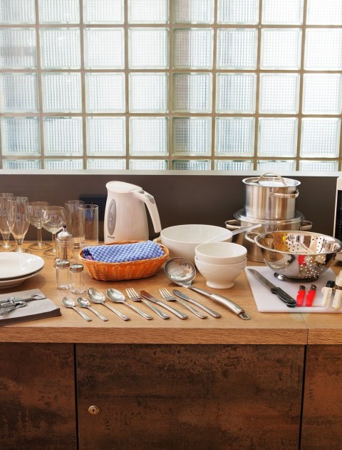 Eine voll ausgestattete Küche mit Geschirr, Besteck, Kochutensilien im möblierten Apartment in Hannover